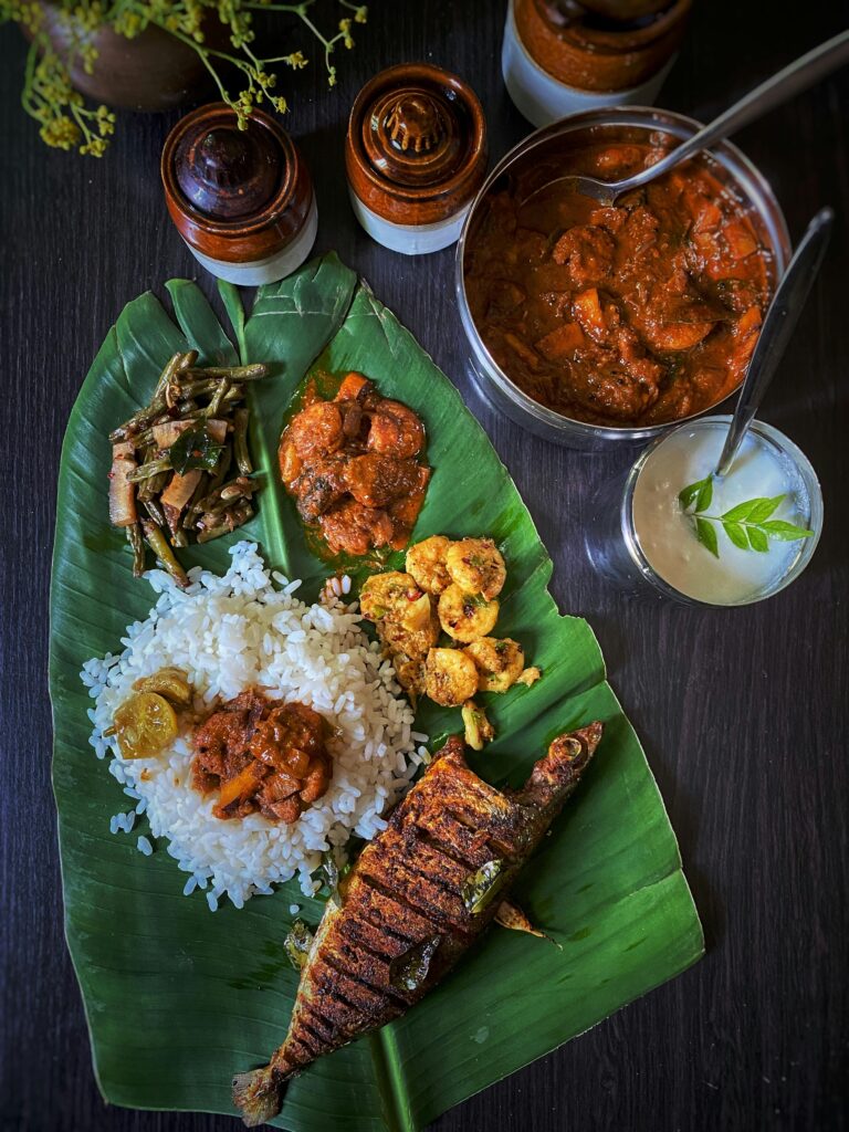 Delicious South Indian meal served on banana leaf with rice and fish curry.
